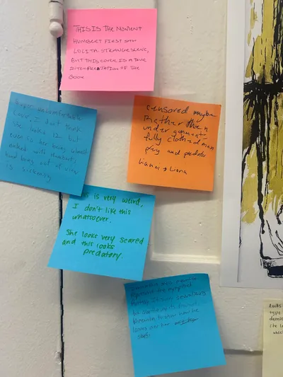Sticky notes in several colours pinned to a wall, carrying students' handwritten critiques of a book cover design and how it represents its subject