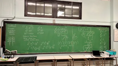 A classroom chalkboard filled with a worked exponent-rules puzzle in a teacher's handwriting, asking students to explain how three ideas relate to each other